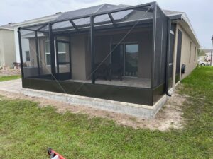 Bronze screen enclosure with kick plate and pavers