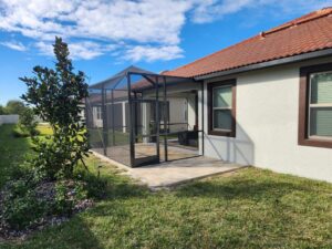 Bronze screen enclosure with paver grill pad