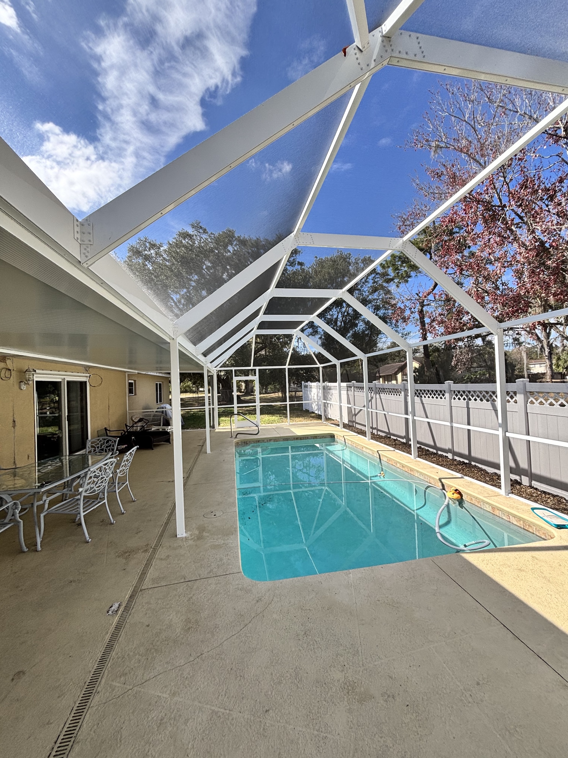 White aluminum pool enclosure with composite roof in Riverview, FL